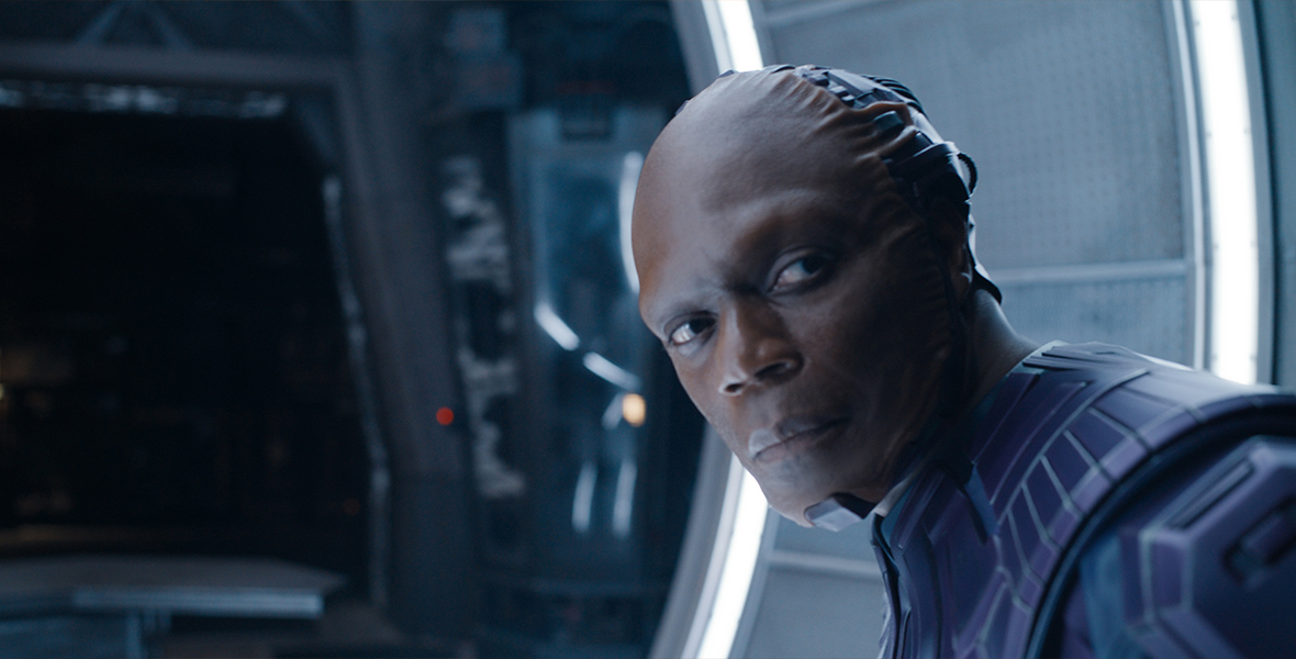 In an image from Marvel Studios’ Guardians of the Galaxy Vol. 3, The High Evolutionary (Chukwudi Iwuji) is leaning over and looking off camera toward the right. He is on a spaceship of some kind.
