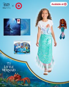 An image of the D23: The Official Disney Fan Club and Target collection of merchandise. Set against a light blue background are images of Target's exclusive Little Mermaid soundtrack vinyl; a young girl with dark hair wearing a Little Mermaid t-shirt and an iridescent skirt that resembles a tail; a Little Mermaid doll, with hair that matches Halle Bailey’s in the film; and a toy collection in a box, including small versions of Ursula, Prince Eric, Ariel, and King Triton. The D23 logo and “bullseye” logo for Target can be seen in the upper left corner, and the Little Mermaid logo can be seen in the lower left. In the upper right, a small graphic says “Available at” with another small “bullseye” logo. At the very bottom of the image, against a white background, are the words “Target Collection, Explore Now.”