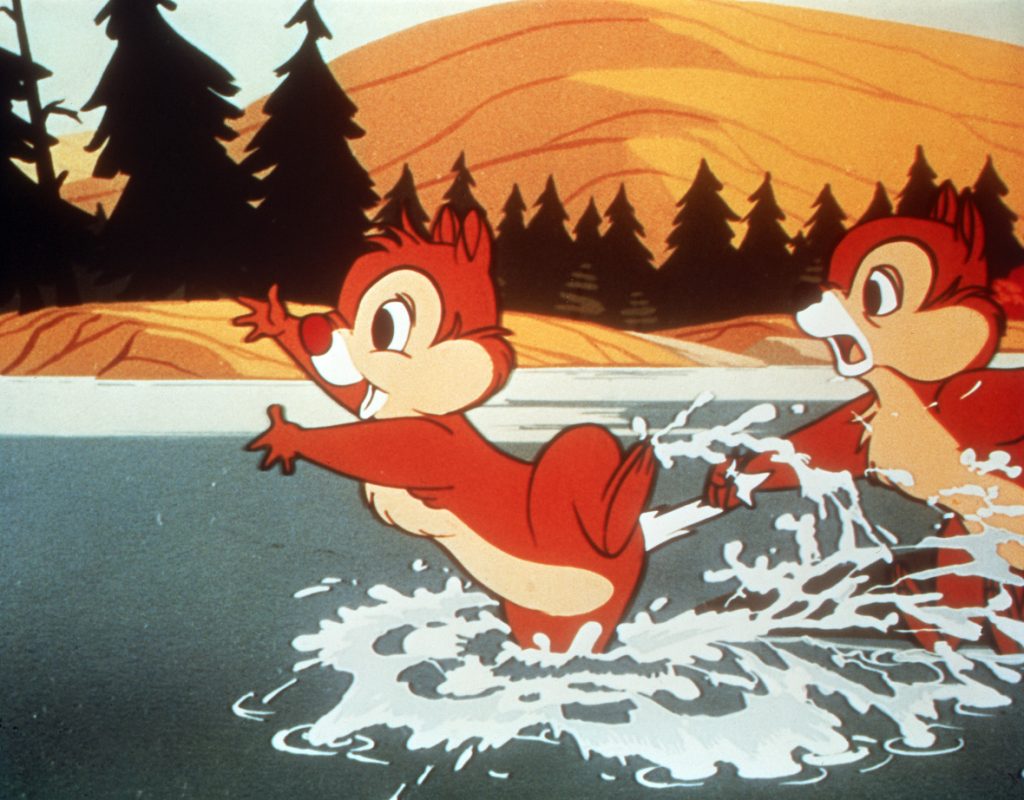 In this image from Chips Ahoy, Chip and Dale skim across the surface of a lake from right to left, with Dale in front and Chip holding onto his tail.