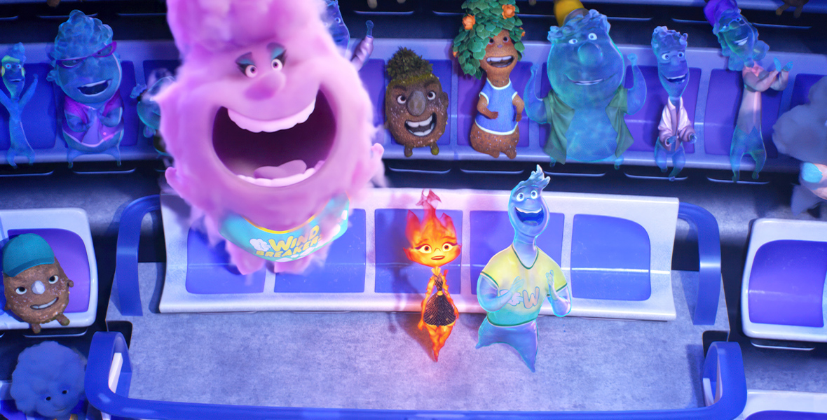 In this image from Disney and Pixar’s Elemental, Ember, a Fire person (voiced by Leah Lewis), on the left, and Wade, a Water person (voiced by Mamoudou Athey), on the right, sit in a VIP box in a stadium. They share the box with Gale (voiced by Wendi McLendon-Covey), who is an Air person that resembles a big, purple storm cloud, looming over Ember and Wade. Surrounding their box seats are regular stadium seats filled with fans watching a sports event with enthusiasm.