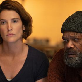 Maria Hill (Cobie Smulders) and Nick Fury (Samuel L. Jackson) wear civilian clothing and sit next to each other in a bar. Both characters appear solemn and weary.