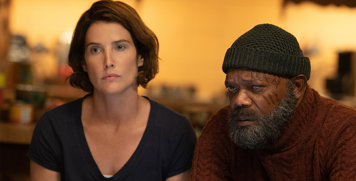 Maria Hill (Cobie Smulders) and Nick Fury (Samuel L. Jackson) wear civilian clothing and sit next to each other in a bar. Both characters appear solemn and weary.