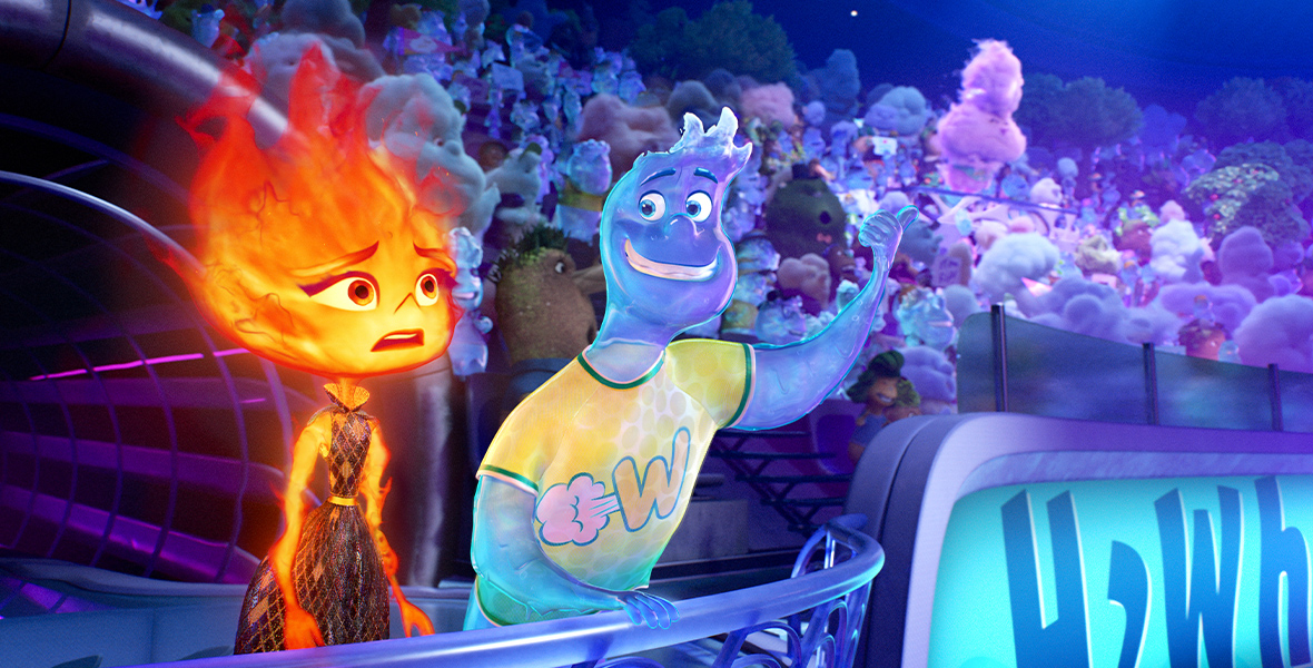 In this image from Disney and Pixar’s Elemental, Wade, a Water person (voiced by Mamoudou Athey), on the right, and Ember, a Fire person (voiced by Leah Lewis), of the left, stand at a railing in the middle of a seating area for a stadium. Behind them, Air people and a few Water people fill the seats, evidently watching a sports competition that is out of frame.