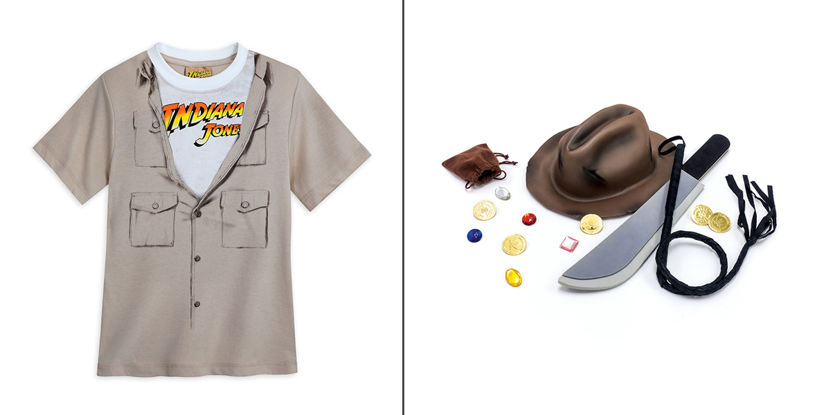 A t-shirt featuring an illustration of a khaki button-down shirt that is unbuttoned to reveal a white shirt with the Indiana Jones films logo on it. A fedora, toy knife, and toy whip are set against a white background next to an open brown pouch that has fake coins and jewels spilling out of it.