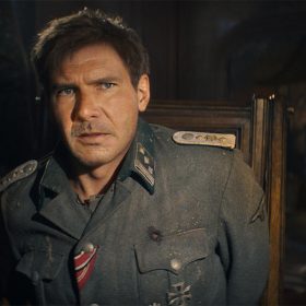 A young Indiana Jones (Harrison Ford) disguises himself in a Nazi uniform.