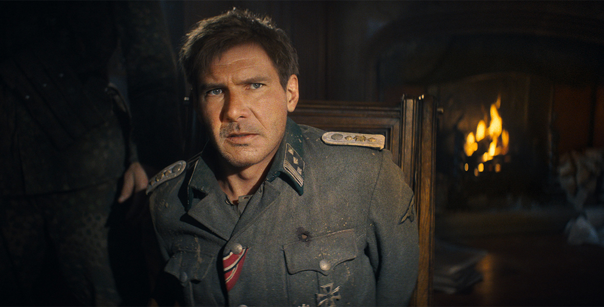 A young Indiana Jones (Harrison Ford) disguises himself in a Nazi uniform.