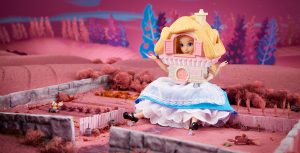 The Alice in Wonderland doll sits in foundation of where a house previously sat in Wonderland. On her head is the house itself, recreating a scene from the Alice in Wonderland animated film.