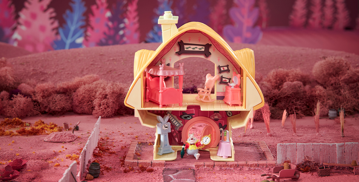 A play set designed to resemble the White Rabbit’s house from Alice in Wonderland. A figure of the white rabbit stands on the bottom floor of the house, while his bedroom is depicted on the top floor.