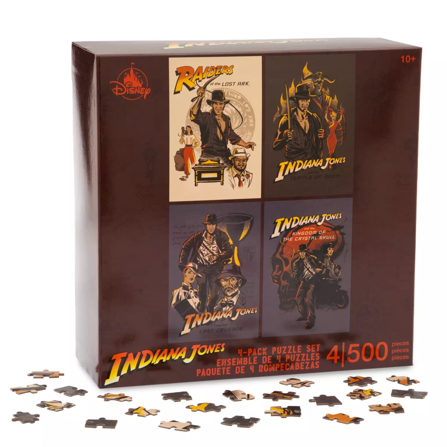 A box for an Indiana Jones puzzle set. The box art features all four finished puzzles, which feature posters for four Indiana Jones films: Indiana Jones and the Raiders of the Lost Ark, Indiana Jones and the Temple of Doom, Indiana Jones and the Last Crusade, and Indiana Jones and the Kingdom of the Crystal Skull.