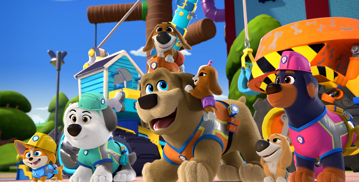 In an image from Disney Branded Television’s Pupstruction, Phinny (voiced by Yonas Kibreab), Luna (voiced by Mica Zeltzer), Tank (voiced by Carson Minniear), the Wagner puppies, and Roxy (voiced by Scarlett Kate Ferguson) are all dressed in their hard hats and construction vests and ready for work. They’re standing in front of their equipment and smiling with excitement.