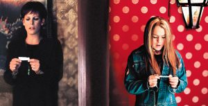 In the film, Freaky Friday, Tess (Jamie Lee Curtis) is standing in front of a black and gold textured wall with a painting on it, while reading a fortune from a fortune cookie; she’s wearing a black dress, black cardigan, and long necklace with a jewel on the end of it. On the opposite side of the door, her daughter, Anna (Lindsay Lohan) is standing in front of red wallpaper with gold polka dots on it, also reading a fortune cookie fortune; she’s wearing a black shirt, jean jacket, green pants, and black studded belt.