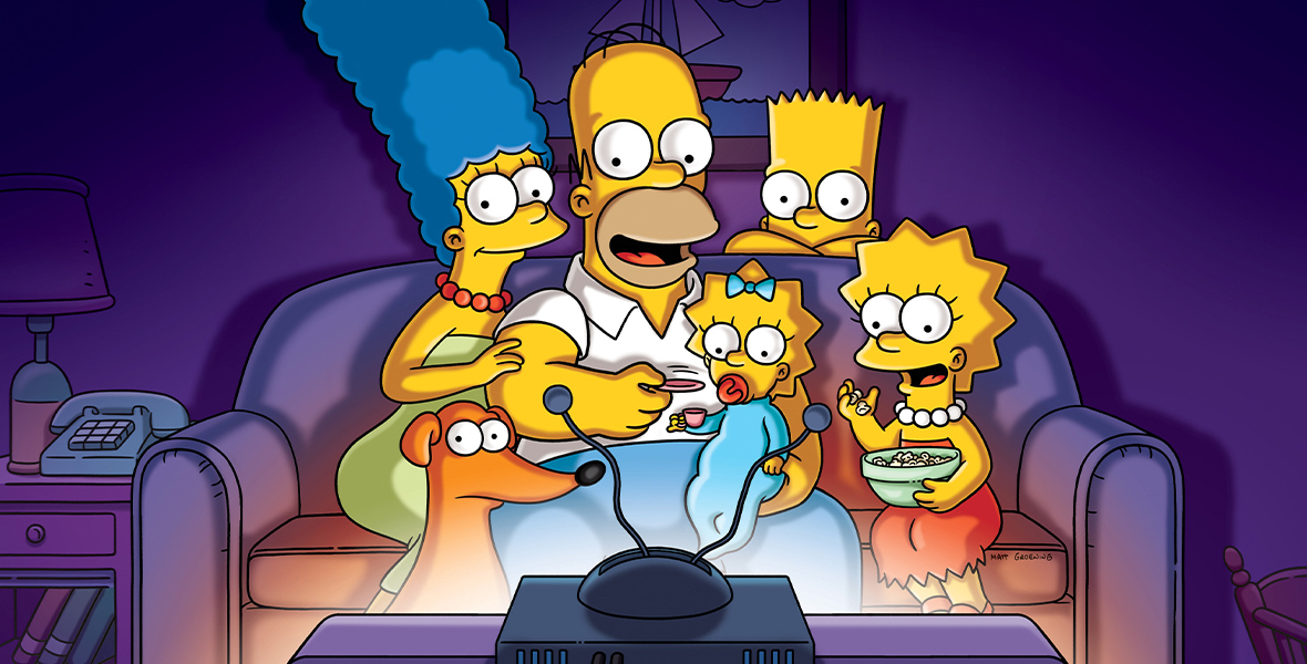 In a promotional image for The Simpsons, the entire Simpsons family is seen on a couch in their living room, watching a television; the light coming out of said TV set is very bright. Seen from left to right are the family dog Santa’s Little Helper, Marge, Homer, Maggie, Bart (who’s somewhat hiding behind the couch), and Lisa.