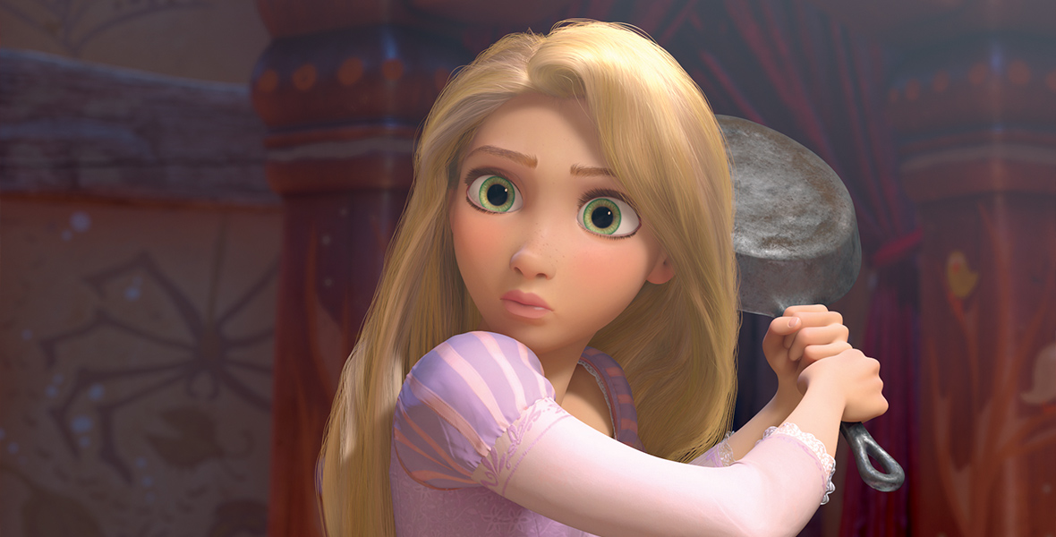 Rapunzel, from the film Tangled, is in a purple dress that has pink sheer sleeves with pink and purple shoulder puffs. She looks shocked while holding a frying pan with both hands in a swinging position behind her.