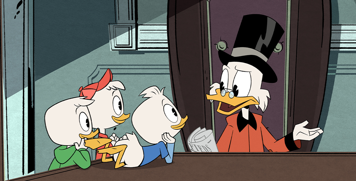 Dewey (voiced by Ben Schwartz), Louie (voiced by Bobby Moynihan, and Huey (voiced by Danny Pudi) lean on a table listening raptly to their uncle, Scrooge McDuck (voiced by David Tennant), while he speaks, in an image from DuckTales.