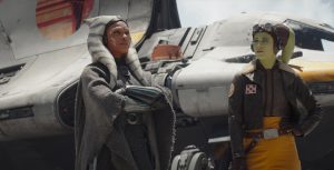 Ahsoka Tano (Rosario Dawson) and Hera Syndulla (Mary Elizabeth Winstead) stand in front of the ship Ghost.