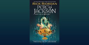 The front full-color cover of Rick Riordan’s new novel Percy Jackson and the Olympians: The Chalice of the Gods, features a golden chalice at the center with classic hieroglyphics decorating it. Atop the chalice rises a green, scaly serpentine monster, with two white chickens with red-tipped wings in agitated poses.