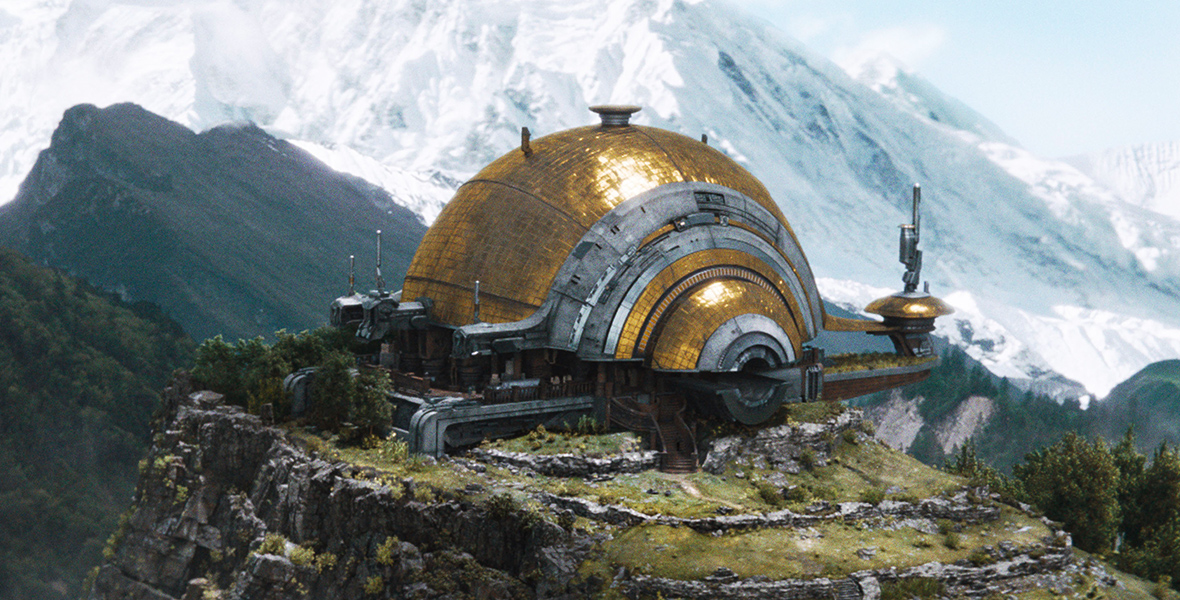 A globular gold and silver building sits atop a mountain in The Creator.