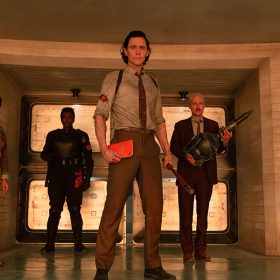 In an image from Marvel Studios’ Loki, from left to right, are Ke Huy Quan as O.B., Wunmi Mosaku as Hunter B-15, Tom Hiddleston as Loki, and Owen Wilson as Mobius.