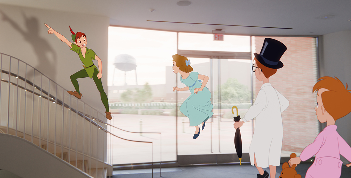 In a scene from the short film Once Upon a Studio, Peter Pan stands on a banister and points up the stairs. To his left, Wendy is flying in the Roy E. Disney Animation Building's lobby. Wendy's younger brothers, John and Michael, are facing in their direction.