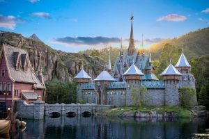 The Arendelle Castle at Hong Kong Disneyland, beautifully positioned on the water, adds a touch of magic to the surroundings.