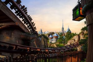 Tracks from Wandering Oaken's Sliding Sleighs are in the foreground. The Arendelle Castle is in the background, far off in the distance.