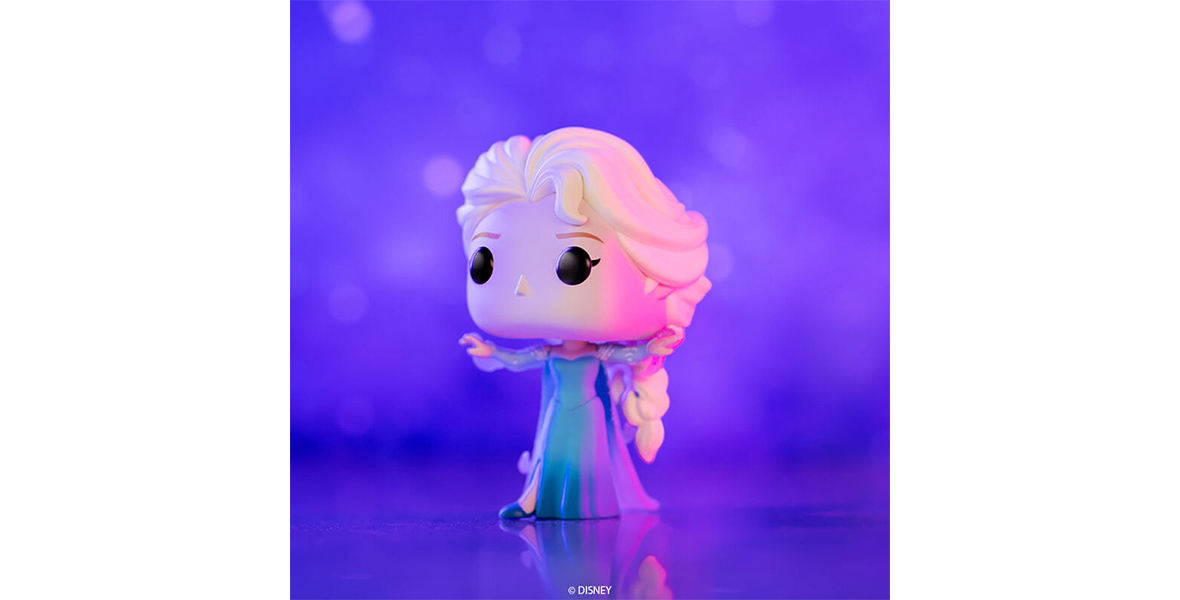 A Funko POP! Vinyl figure of Elsa, wearing her blue dress from the original Frozen movie and holding out her arms as if she is manipulating ice.  