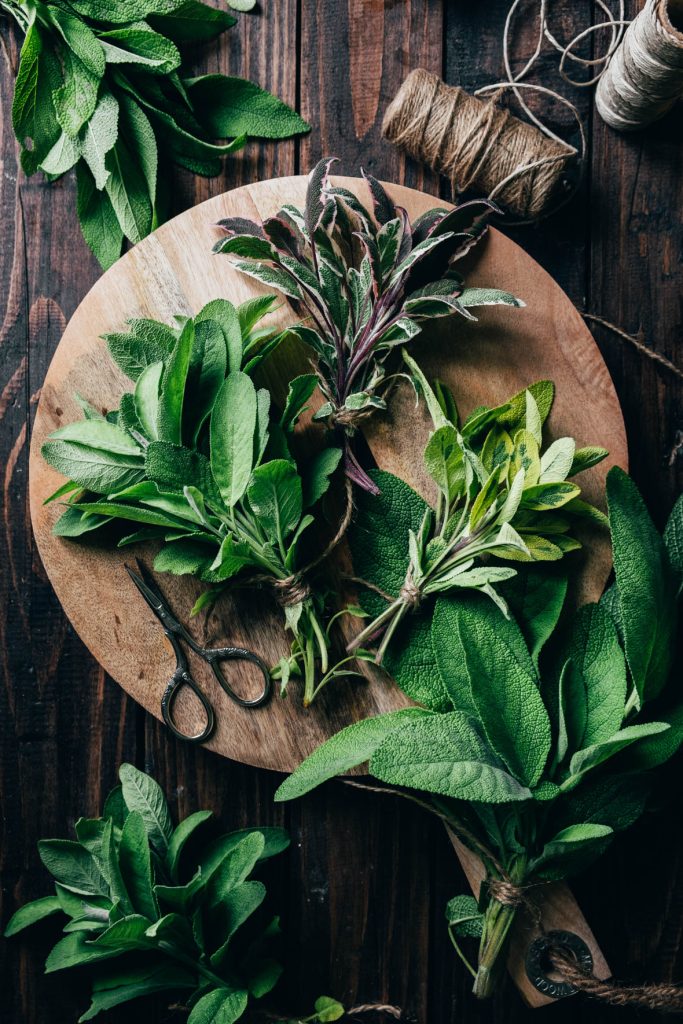 Different kind of sage on a wooden cutting board