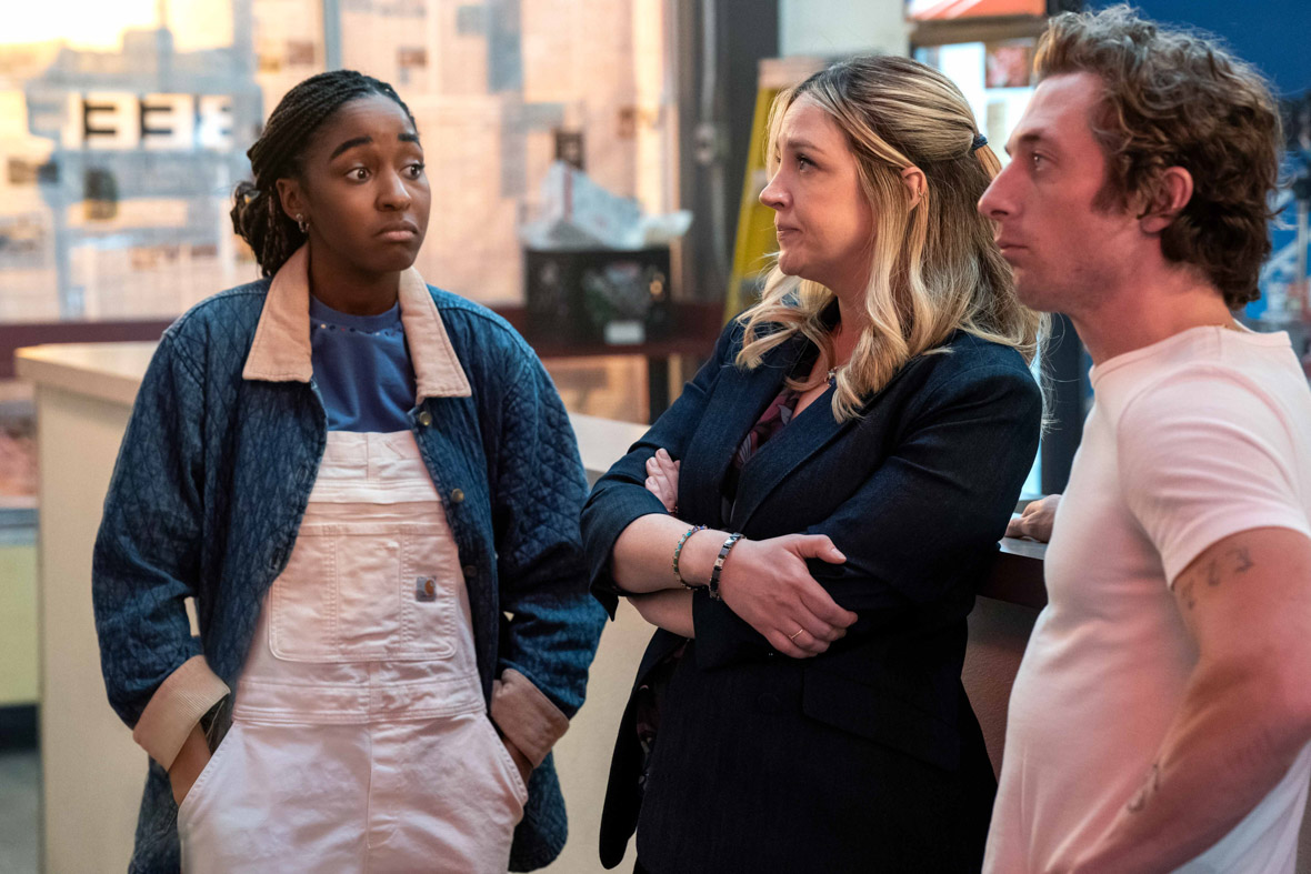 Sydney Adamu, played by Ayo Edibiri, Natalie "Sugar" Rose Berzatto, played by Abby Elliott, and Carmen "Carmy" Berzatto, Jeremy Allen White, look puzzled in The Bear.
