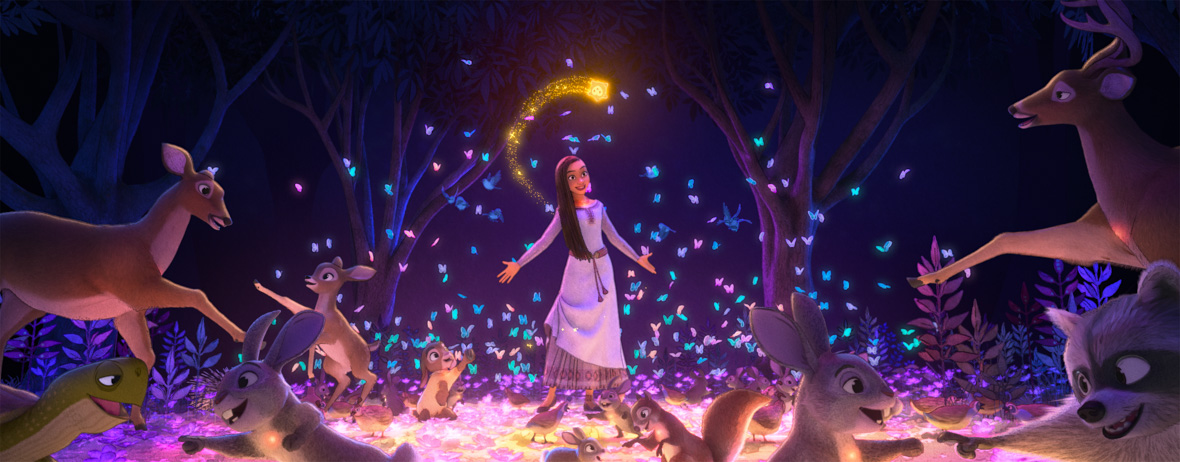 In scene from Wish, Asha stands with her arms outstretched as star shines bright above her. They are surrounded by deer, rabbits, raccoons, turtles, and other forest animals.