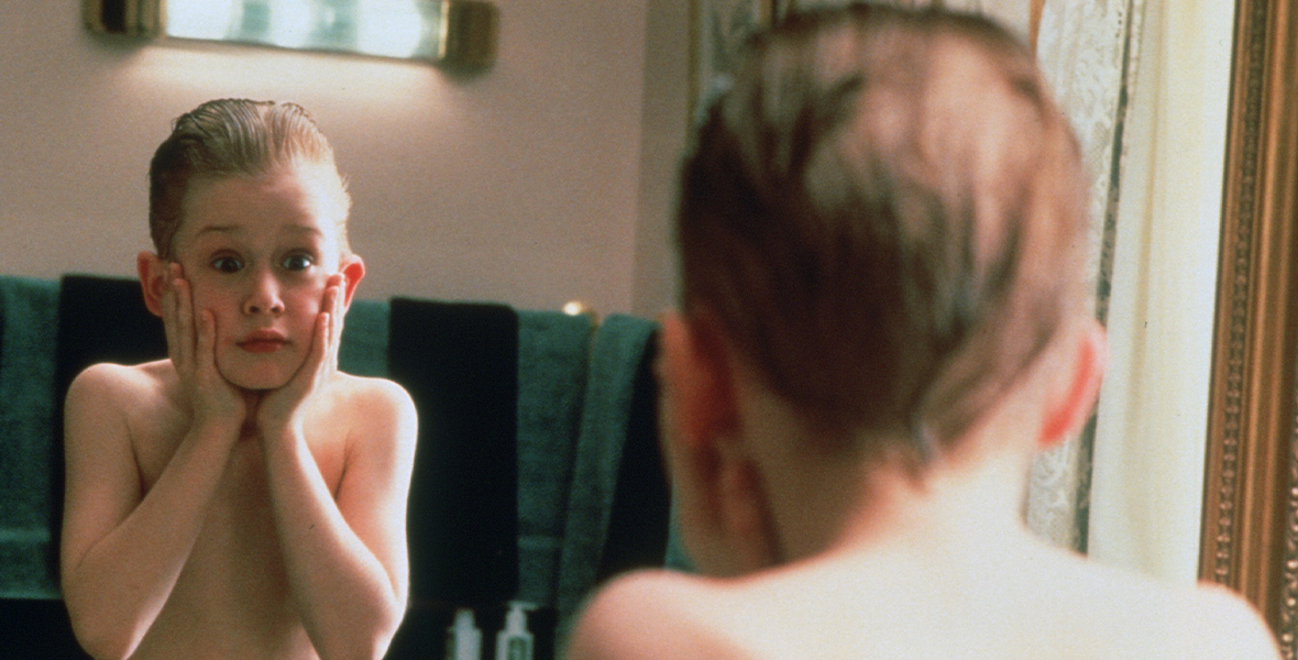 In a now-iconic image from Home Alone, Kevin McCallister (Macaulay Culkin) is looking in the mirror, his palms to his cheeks after putting aftershave on his face; the burning has caused him to yell out in pain.