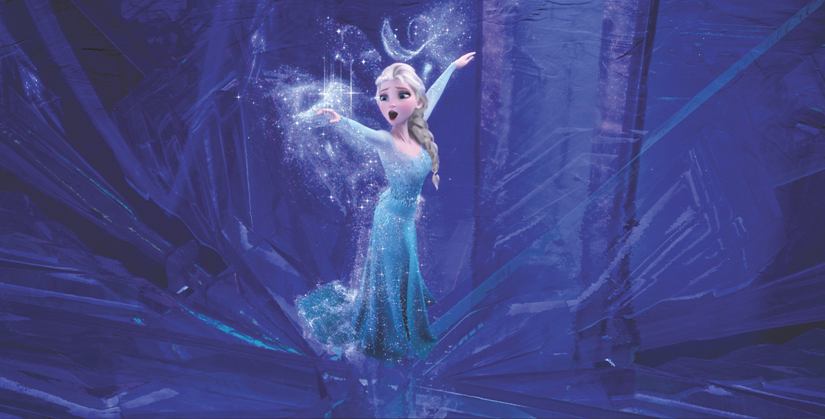 In an image from Walt Disney Animation Studios’ Frozen, Elsa (voiced by Disney Legend Idina Menzel) is inside the ice castle she just created. She’s wearing the iconic icy blue gown; crystals are flying from her hands, and she is singing.