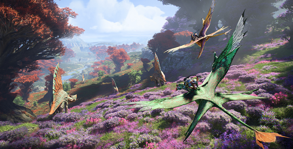 Several Na’vi ride their banshees over a field of purple flowers. In the distance, a valley with orange-leafed trees sprawls to the horizon.