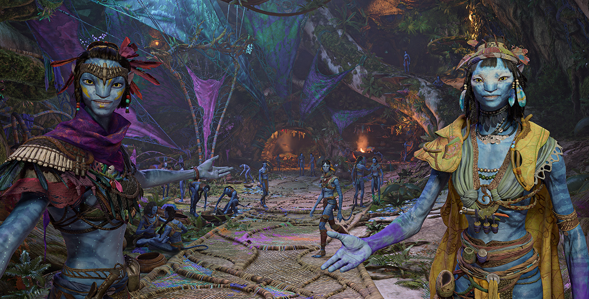 Two Na’vi welcome you with extended arms into a covered area where a variety of Na’vi are relaxing.