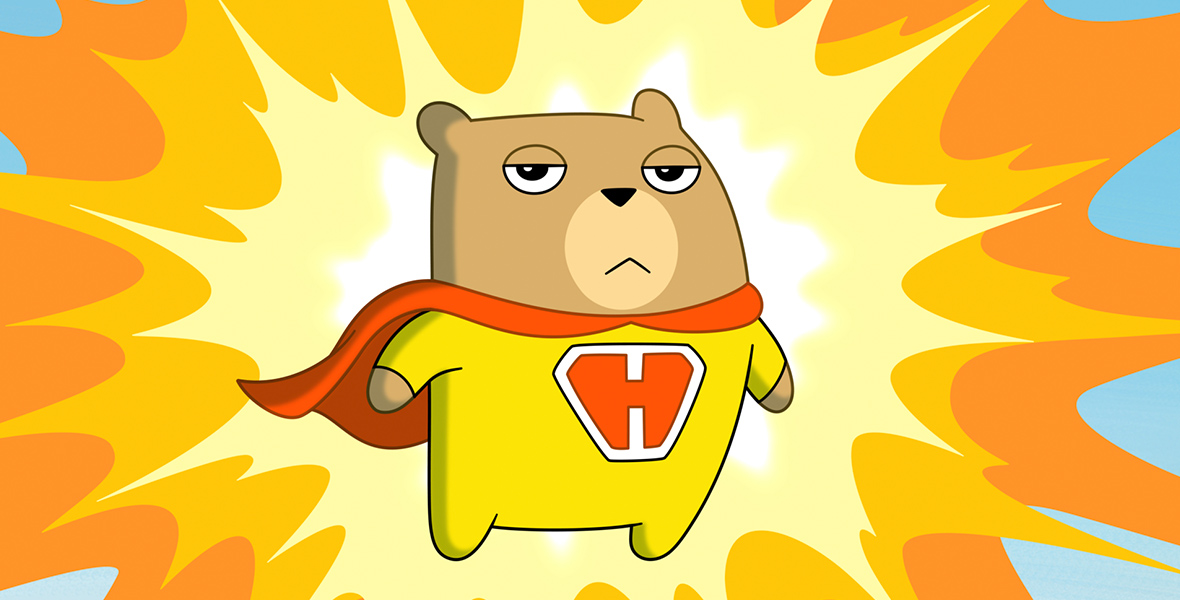 In an image from Disney Branded Television’s Hamster & Gretel, Hamster (voiced by Beck Bennett) is wearing his yellow super hero suit and cape, and is set against a bright yellow “Pow!” comic book-style background. There is a large “H” in red on his chest.
