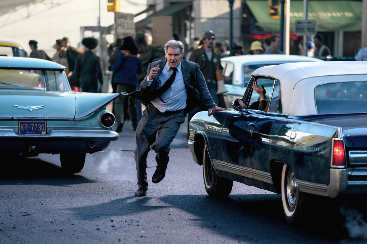 In a scene from Lucasfilm’s Indiana Jones and the Dial of Destiny, Indiana Jones, played by Harrison Ford, runs through a busy city street crowded with cars and passersby.