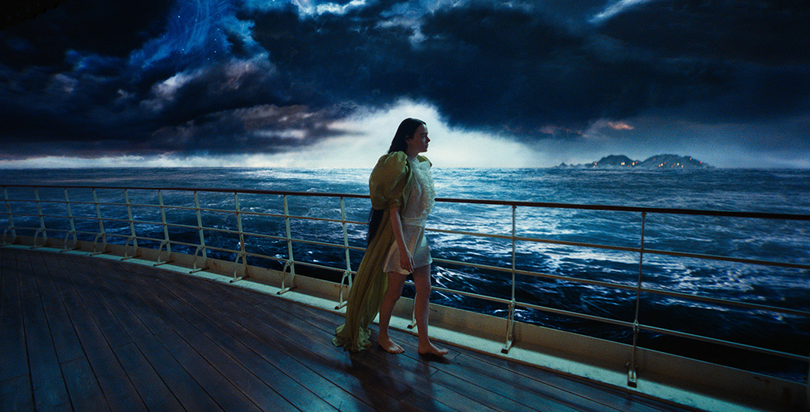 Bella Baxter, played by Emma Stone, walks across a ship deck in Poor Things.