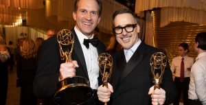 Luke Lloyd-Davies and David Furnish, executive producers of Elton John Live: Farewell from Dodger Stadium, pose with their Emmy Awards at The Walt Disney Company’s post-Emmys party.