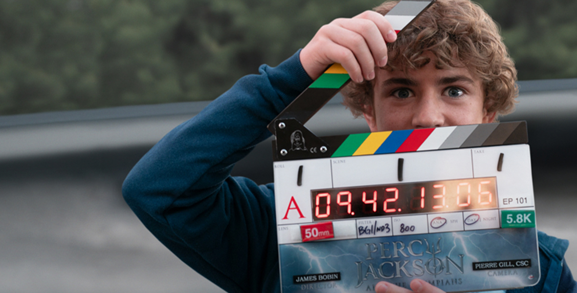 Walker Scobell holds a slate on the set of Percy Jackson and the Olympians.