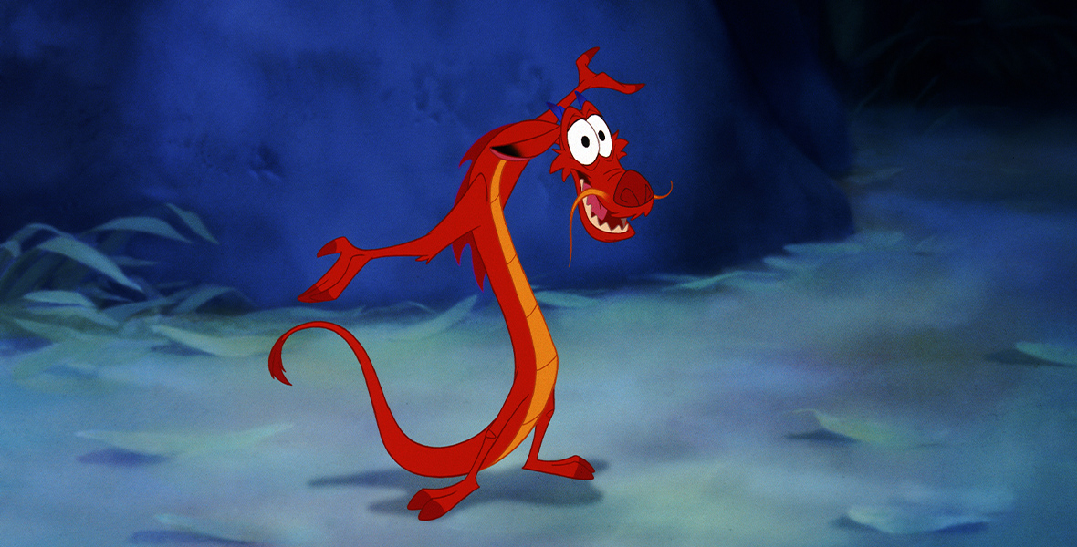 Mushu, a small, red dragon, stands with his arms open, as if welcoming someone.