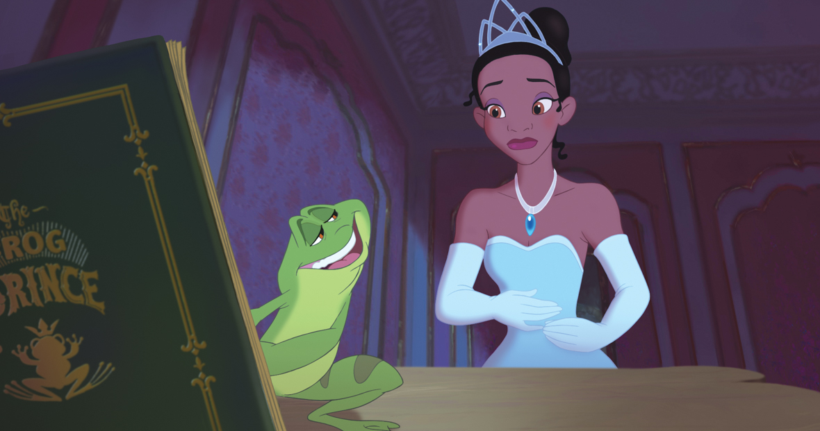 Princess Tiana (left) is wearing a voluminous, strapless blue gown, matching blue gloves, a necklace, and a tiara. She appears worried as she gazes at the Frog (right), who is showing her the pages of a green book titled “The Frog Prince,” featuring a frog wearing a crown on its cover.