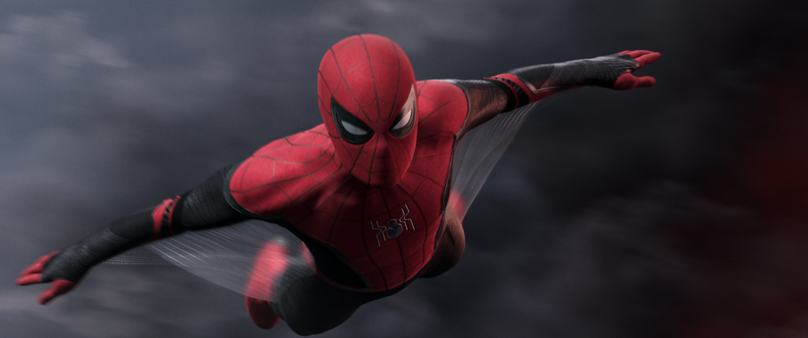 Spiderman, played by Tom Holland, is wearing his Super Hero costume and, facing the lens, is flying.