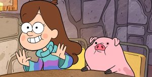 In a scene from Gravity Falls, Mabel Pines and Waddles, her pet pig, sit on a wooden table, both looking excitedly at something in front of them. Mabel is wearing a blue and pink turtleneck sweater and is smiling widely with her palms lifted.