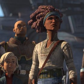 From left to right: Tech, Omega, Wrecker, Phee Genoa, and Hunter from Star Wars: The Bad Batch. All are looking toward something except Tech, who is focused on a gadget while wearing glasses with orange lenses. They are all wearing gray armor with red detailing. Additionally, Phee Genoa and Hunter wear a green and red bandana, respectively.