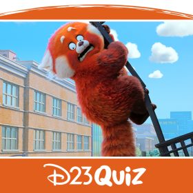 Mei Lee, transformed into a red panda, clings desperately to a railing attached to a brick building that is detaching and about to plummet to the ground. The frightened red panda wears a distressed expression, set against a backdrop of similar brick buildings and a blue sky.