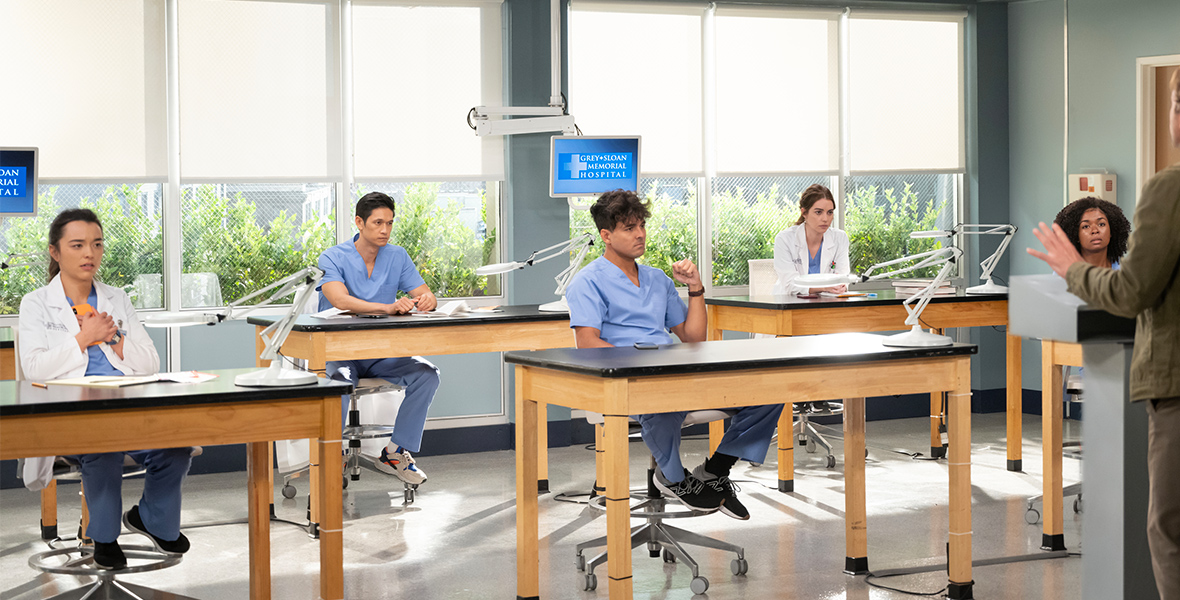Grey Sloane Memorial interns Mika Yasuda, played by Midori Francis, Benson Kwan, played by Harry Shum Jr., Lucas Adams, played by Niko Terho, Jules Millin, played by Adelaide Kane, and Simone Griffith, played by Alexis Floyd, wear blue scrubs and sit by themselves at various lab stations; they all have exasperated expressions on their faces. Dr. Nick Marsh, played by Scott Speedman, stands behind a lectern and addresses the interns.