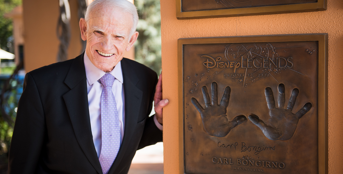 Disney Legend Carl Bongirno poses with his bronzed handprints at Legends Plaza.
