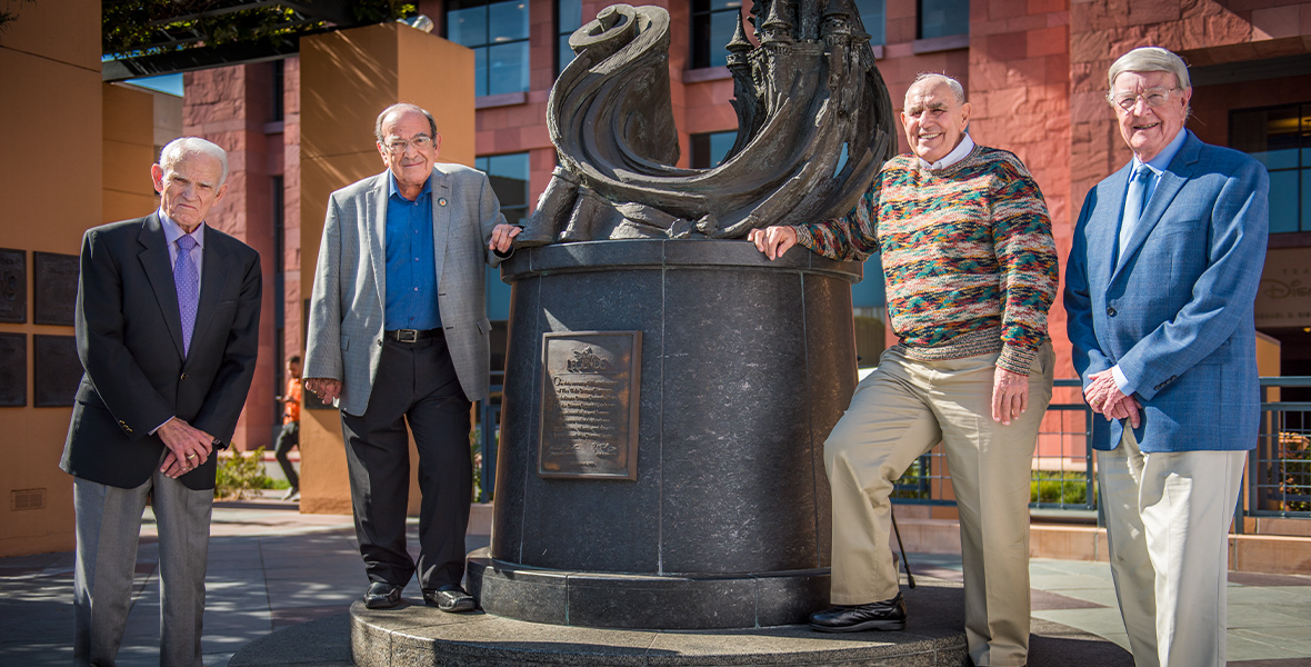 Carl Bongirno and three other Disney Imagineers pose for a photo in Legends Plaza.