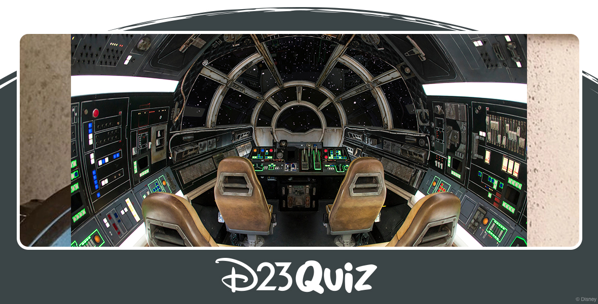 The inside of the Millennium Falcon: Smugglers Run attraction is a faithful recreation of the iconic Star Wars ship, featuring black walls adorned with switches and buttons, and a main view screen surrounded by seats in a semi-circle arrangement. The leather seats are weathered, and neon strips surround some of the buttons.