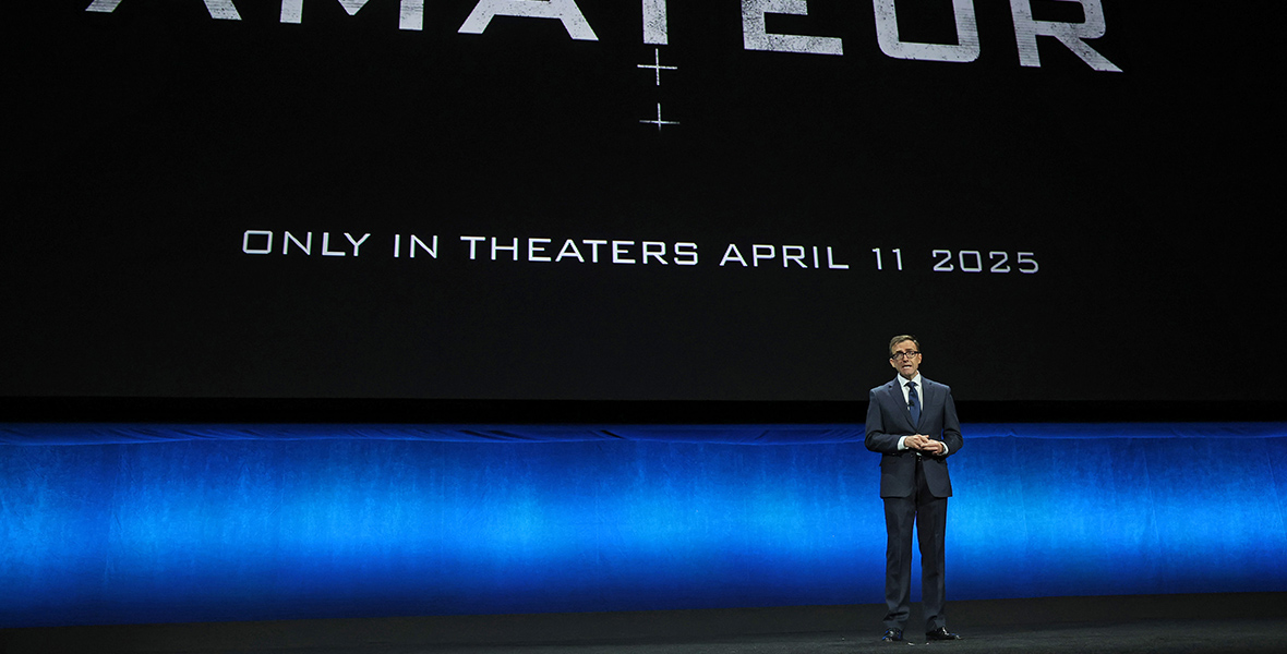 Tony Chambers, E.V.P., Head of Theatrical Distribution, speaks onstage during the Walt Disney Studios presentation at Cinemacon. Behind him on screen is the logo for the film The Amateurs along with the text “Only in theaters April 11, 2025”.