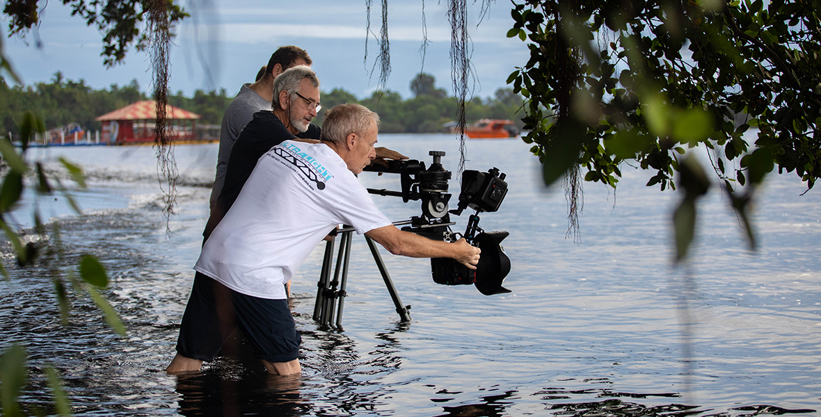 Director and DOP Adam Geiger operates a jib arm with Producer/Camera Operator Rory McGuiness and Camera Assistant Woody Spark, surrounded by knee-deep water.